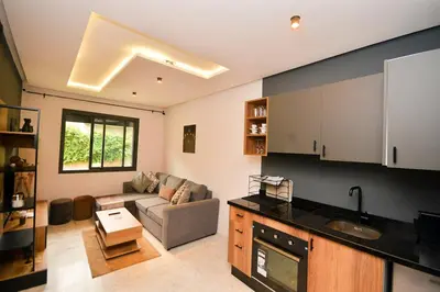 a kitchen and living room with a couch and a table at Atelier Aedes - Studio 1 in Maarif