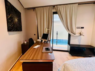 a bedroom with a desk with a computer on it at Villa Bahia Golf beach - Bouznika in Casablanca