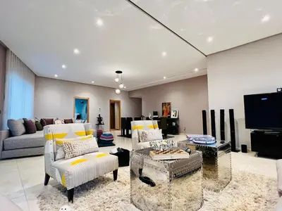 a living room with couches and a tv at Villa Bahia Golf beach - Bouznika in Casablanca