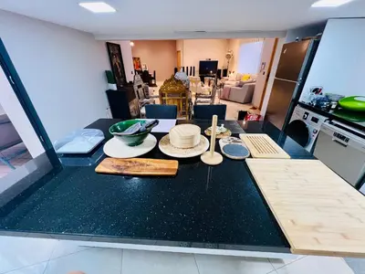 a kitchen with a table with plates and bowls on it at Villa Bahia Golf beach - Bouznika in Casablanca