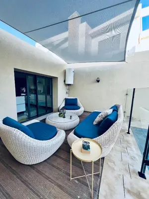 a living room with two chairs and a table at Villa Bahia Golf beach - Bouznika in Casablanca