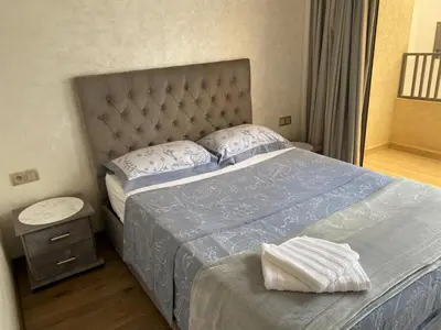 a bedroom with a bed with a blue comforter at 1 bed with balcony near CFC in Casablanca