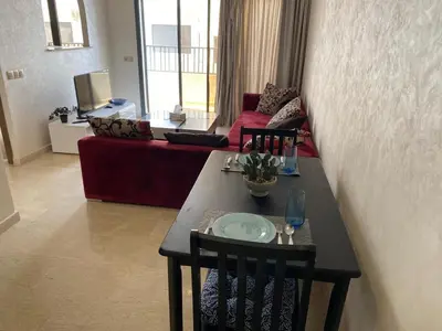 a living room with a table and a couch at 1 bed with balcony near CFC in Casablanca