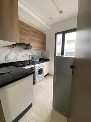 a kitchen with a stove and a dishwasher at 1 bed with balcony near CFC in Casablanca