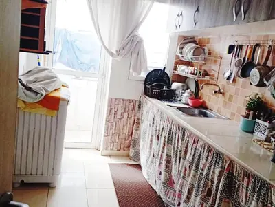 a kitchen with a counter and a sink and a window at espace chaleureux in Aïn ej Jmel