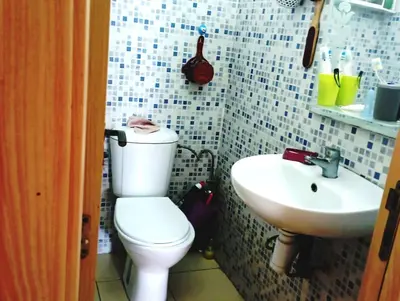 a bathroom with a white toilet and a sink at espace chaleureux in Aïn ej Jmel