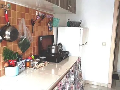 a kitchen with a stove and a refrigerator at espace chaleureux in Aïn ej Jmel