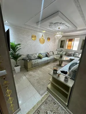 a living room with a couch and a table at Ahmed 205 in Temara
