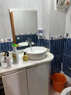 a bathroom with a sink and a mirror at Ahmed 205 in Temara