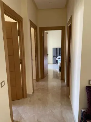 a hallway of a room with doors and a bedroom at Casabay SidiRahal Appartement à louer in Sidi Rahal