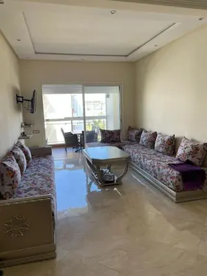 a living room with a couch and a table at Casabay SidiRahal Appartement à louer in Sidi Rahal