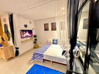 a bedroom with a bed and a tv in it at nouveau penthouse en plein centre de casa in Casablanca