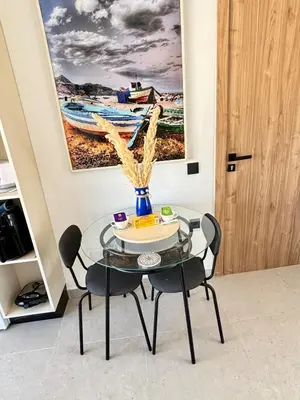 a glass table with a vase on it in a room at nouveau penthouse en plein centre de casa in Casablanca