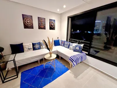 a living room with a couch and a window at nouveau penthouse en plein centre de casa in Casablanca
