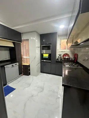 a kitchen with white marble flooring and a large appliance at McDonalds Apartment 2 Mars in Casablanca