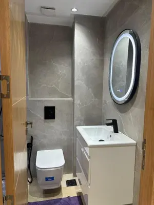 a bathroom with a sink and a toilet and a mirror at McDonalds Apartment 2 Mars in Casablanca
