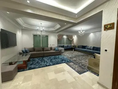 a large living room with a couch and a tv at McDonalds Apartment 2 Mars in Casablanca