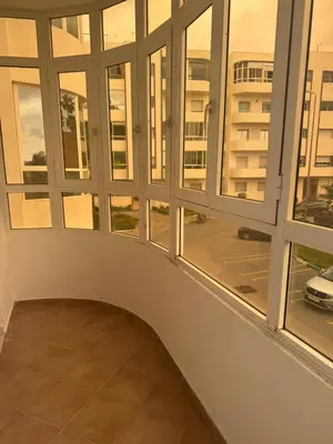 a room with large windows and a balcony at Appartement Sara in Mohammedia
