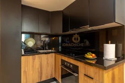 a kitchen with black cabinets and a bowl of fruit on the counter at Butterfly 703 Harve de paix au Cœur de Casablanca in Casablanca