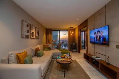 a living room with a couch and a flat screen tv at Butterfly 703 Harve de paix au Cœur de Casablanca in Casablanca