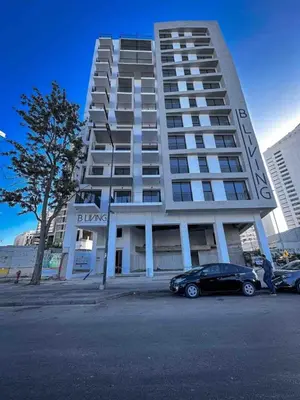 a large building with a car parked in front of it at Butterfly 703 Harve de paix au Cœur de Casablanca in Casablanca