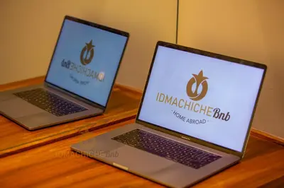 two laptop computers sitting on top of a wooden table at Butterfly 703 Harve de paix au Cœur de Casablanca in Casablanca