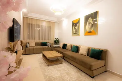 a living room with a couch and a table at Appartement Cosy Casablanca in Casablanca