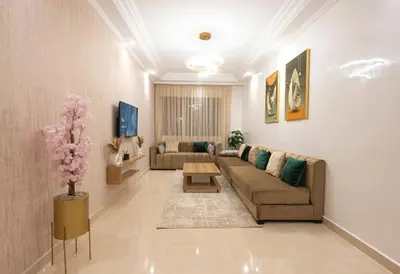 a living room with a couch and a table at Appartement Cosy Casablanca in Casablanca