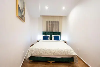 a bedroom with a large bed with blue pillows at Appartement Cosy Casablanca in Casablanca
