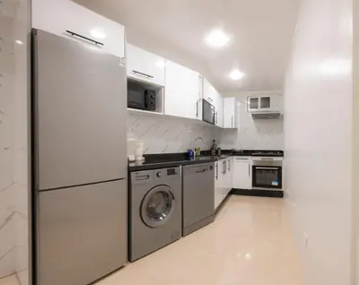 a kitchen with a refrigerator and a washer and dryer at Appartement Cosy Casablanca in Casablanca