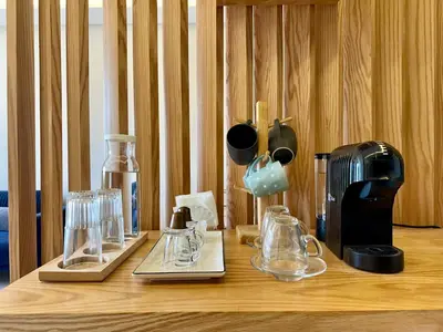 a wooden table topped with glasses and a coffee maker at AeroRelax, free Parking, WI-FI in Nouaseur
