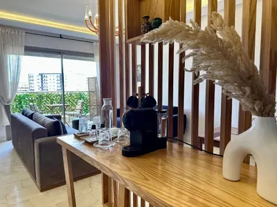 a living room with a table with wine glasses on it at AeroRelax, free Parking, WI-FI in Nouaseur