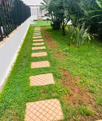 a garden with stepping stones in the grass at W&M LUXOR residence TEMARA in Temara