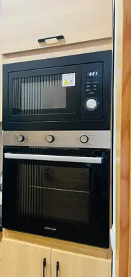 a microwave oven sitting on top of a cabinet at W&M LUXOR residence TEMARA in Temara