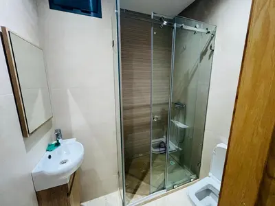 a bathroom with a shower and a sink and a toilet at W&M LUXOR residence TEMARA in Temara