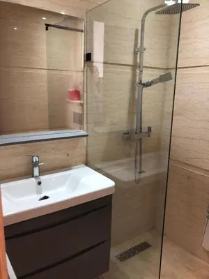 a bathroom with a sink and a shower at Appartement Sidi Rahal Oceanic in Sidi Rahal