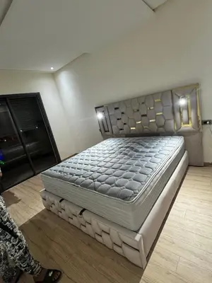a bedroom with a large bed in a room at Family in Dar Bouazza