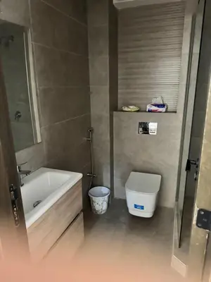 a bathroom with a tub and a toilet at Family in Dar Bouazza