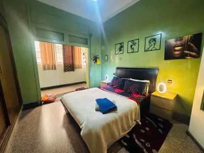 a bedroom with a bed with a blue pillow on it at Le belvédère in Casablanca