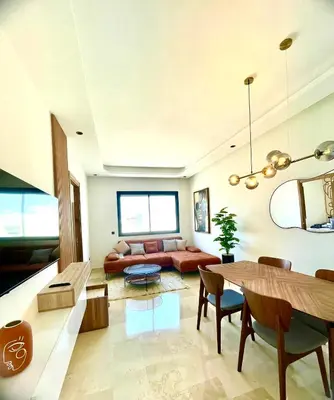 a living room with a couch and a table at Maarif Picasso Studio & Private Terrace & Parking in Casablanca