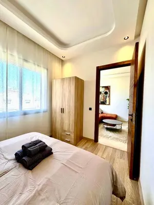 a bedroom with a large bed and a mirror at Maarif Picasso Studio & Private Terrace & Parking in Casablanca
