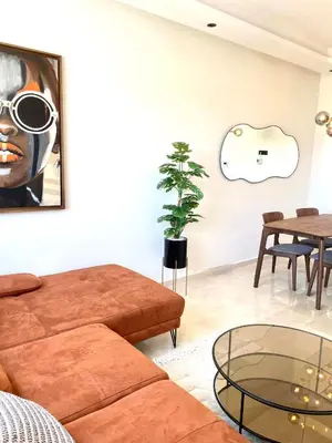 a living room with a couch and a table at Maarif Picasso Studio & Private Terrace & Parking in Casablanca