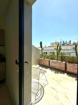 a view of a balcony from a door with a chair at Maarif Picasso Studio & Private Terrace & Parking in Casablanca