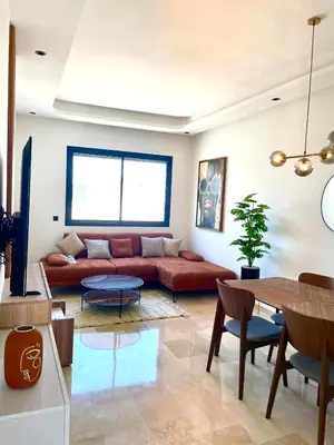 a living room with a couch and a table at Maarif Picasso Studio & Private Terrace & Parking in Casablanca