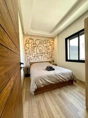 a bedroom with a bed with a graffiti covered wall at Maarif Picasso Studio & Private Terrace & Parking in Casablanca
