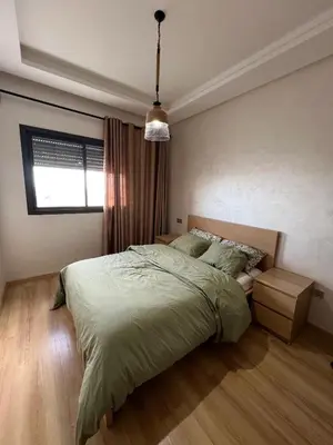 a bedroom with a large bed and a window at Ocean park zenata in Aïn Harrouda