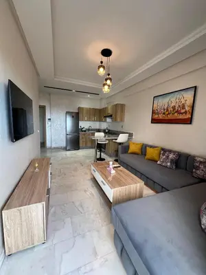 a living room with a couch and a table at Ocean park zenata in Aïn Harrouda