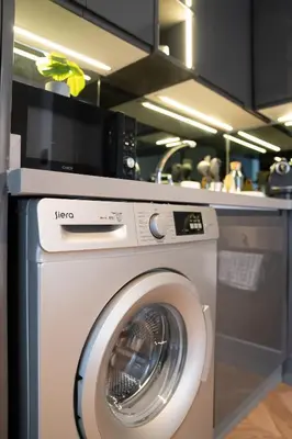 a kitchen with a washing machine in a kitchen at Central Cozy & Great Location with 2 Balconies Fast Wifi 2 Minutes to KFC Mcdo Bd 2 Mars in Casablanca