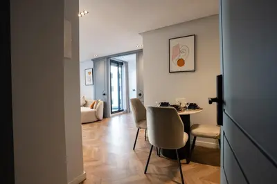 a living room with a table and chairs at Central Cozy & Great Location with 2 Balconies Fast Wifi 2 Minutes to KFC Mcdo Bd 2 Mars in Casablanca