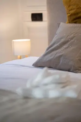 a bedroom with a bed with a pillow and a lamp at Central Cozy & Great Location with 2 Balconies Fast Wifi 2 Minutes to KFC Mcdo Bd 2 Mars in Casablanca